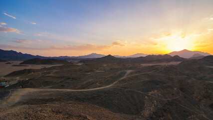 Wonderful landscape,Arabian desert of stone, Egypt with mountains at sunset.To the left of the desert nomad huts,
