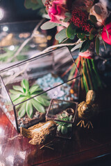 Gold wedding ring looks beautiful on the glass surface on the background of red wedding bouquet