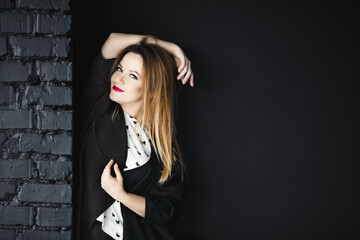 Fototapeta premium The stylish girl stands near wall