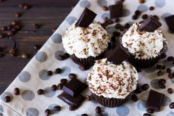 Chocolate-coffee cupcakes on a dark wooden background