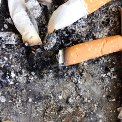 Close up cigarette butts for background.