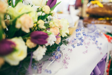 Branch of violet crystals lies on dinner table