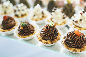 Baked baskets with chocolate cream stand on glass plate