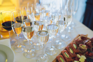 Champagne flutes stand on white table