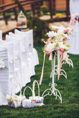 Three white baskets stand on green lawn