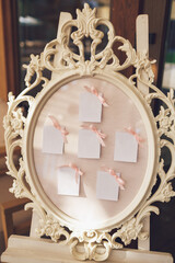 Round wooden frame with original design and white cards pinned to it