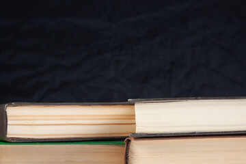 Books on the table close-up on a black background