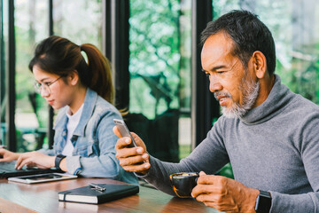 Portrait Smiling Attractive mature man with white stylish short beard using smartphone. Serving...