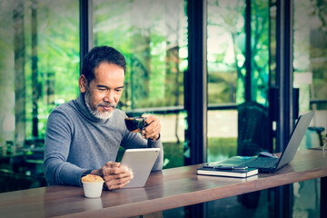 Portrait Smiling Attractive mature man with white stylish short beard using smartphone. Serving...