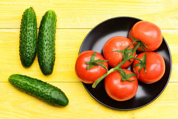 vegetable concept, cucumbers with tomato on plate on yellow vintage