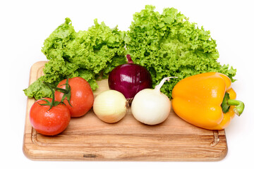 vegetables or lettuce leaf, tomatoes, onions, pepper on cutting board