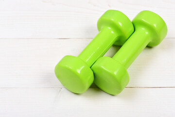 green dumbbells on white vintage with exercise concept