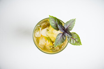 Fresh cocktail with grape, lime and basil leaves. Shallow depth of field.