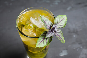 Fresh cocktail with grape, lime and basil leaves. Shallow depth of field.