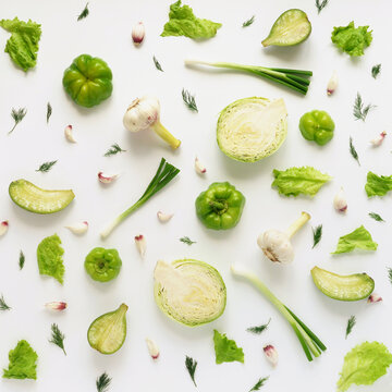 Fresh vegetables on a white background. Vegetable food background. Pattern of cabbage, radish, lettuce, green pepper, young garlic, sorrel. Top view.
