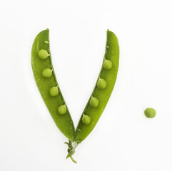Green peas in open pod, isolated on white background. Top view