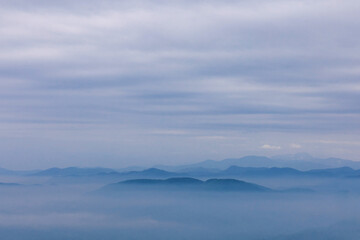 Fototapeta na wymiar Blue mountains and sky with milky foggy and clouds