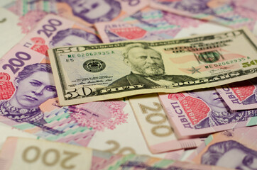 Fifty dollars banknote on the background of ukrainian hryvnas
