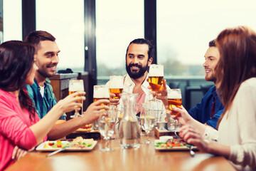friends dining and drinking beer at restaurant