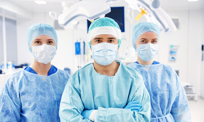 group of surgeons in operating room at hospital