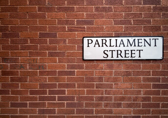 Wall with a sign of Parliament Street. It is believed that this is the narrowest street in the world. Exeter. Devon. England