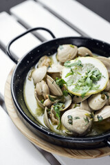 stewed clams in garlic herb and white wine seafood sauce