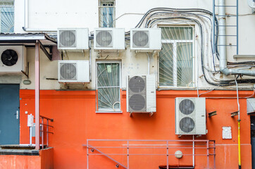 Many compressor airs are hanging on a wall