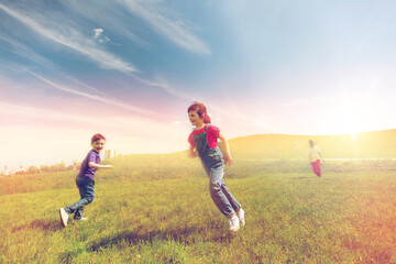 group of happy kids running outdoors