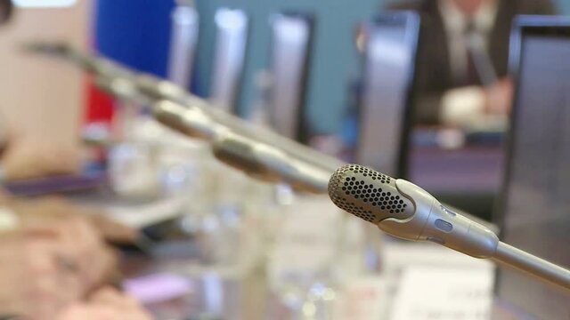 The hands of the politicians at the meeting  .The microphones at the meeting for officials.