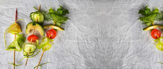 Concept of simple vegetarian eating, Fruits, vegetables on party picks. Top view. Copy space. Wide panoramic image.