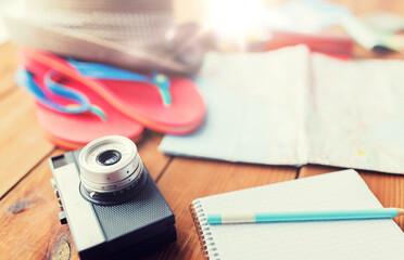 close up of camera, notepad and travel stuff