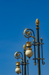 Fototapeta na wymiar Street lights by Royal palace in Madrid