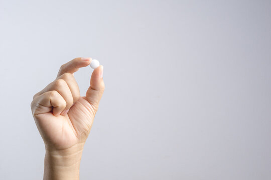 Hand Holding Medical Pill