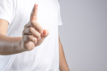 Hand with blood drop at finger from needle for sample testing