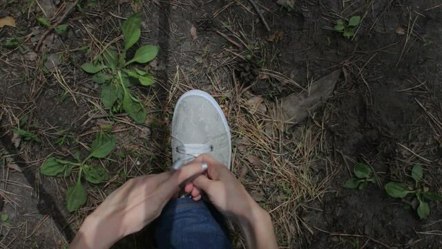 Woman Hiker Tying Laces On Sneakers At Forest Trail, Close Up, POV