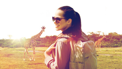 happy woman with backpack traveling in africa