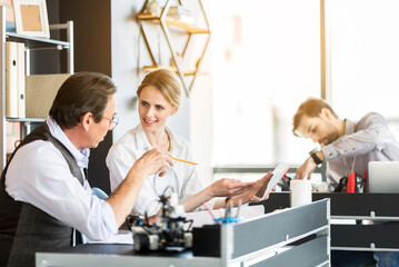 Professional team of engineers cooperating at work