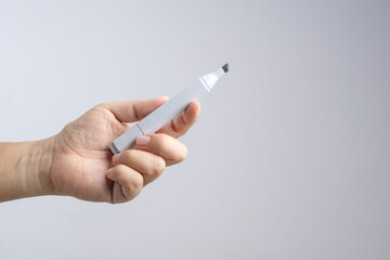 Hand holding gradient level adjustment permanent marker