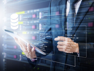 Double exposure of professional businessman connecting database with tablet devices on hand in Cloud technology and business concept