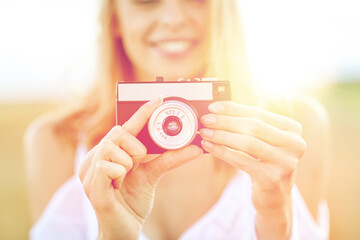 close up of woman photographing with film camera