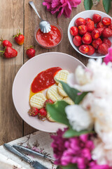Dumplings from rice flour and cottage cheese with a pitted strawberry