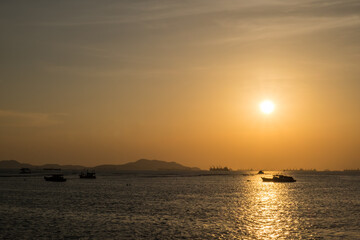Silhouette boat in the sea on during sunset