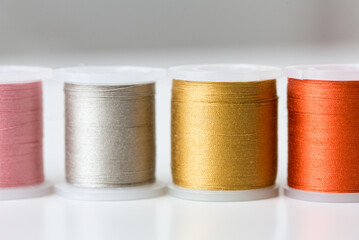 row of colorful thread spools on table