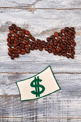 Image of money, coffee bean. Coffee bow on wooden background.