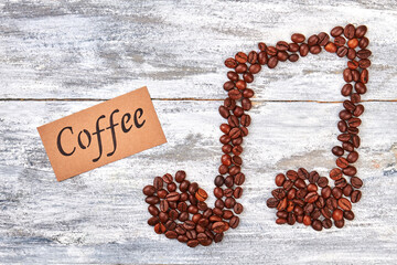 Tune from coffee beans, message. Coffee beans melody, wooden background.