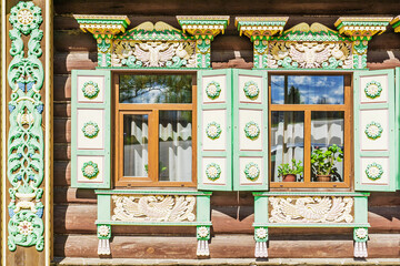 Fototapeta na wymiar Carved platbands in the Russian wooden house