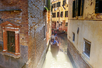 Gondolas on narrow canals in venice