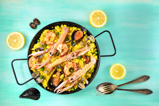Spanish seafood paella with lemons and copyspace