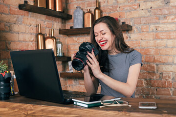 Fototapeta na wymiar Young freelancer girl is working hard in laptop in loft interior