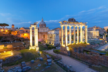 Fototapeta na wymiar Ancient ruins of a Roman Forum or Foro Romano during evening blue hour in Rome, Italy. View from Capitoline Hill